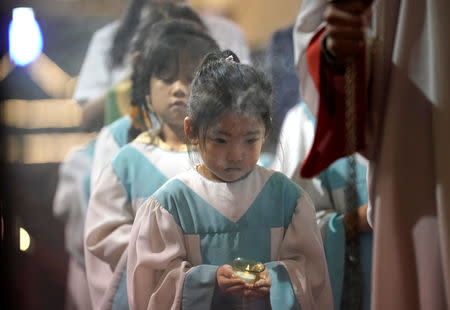 Altar girls hold candles during a weekend mass at Beijing South Catholic Church, a government-sanctioned Catholic church, in Beijing, China September 29, 2018. REUTERS/Jason Lee