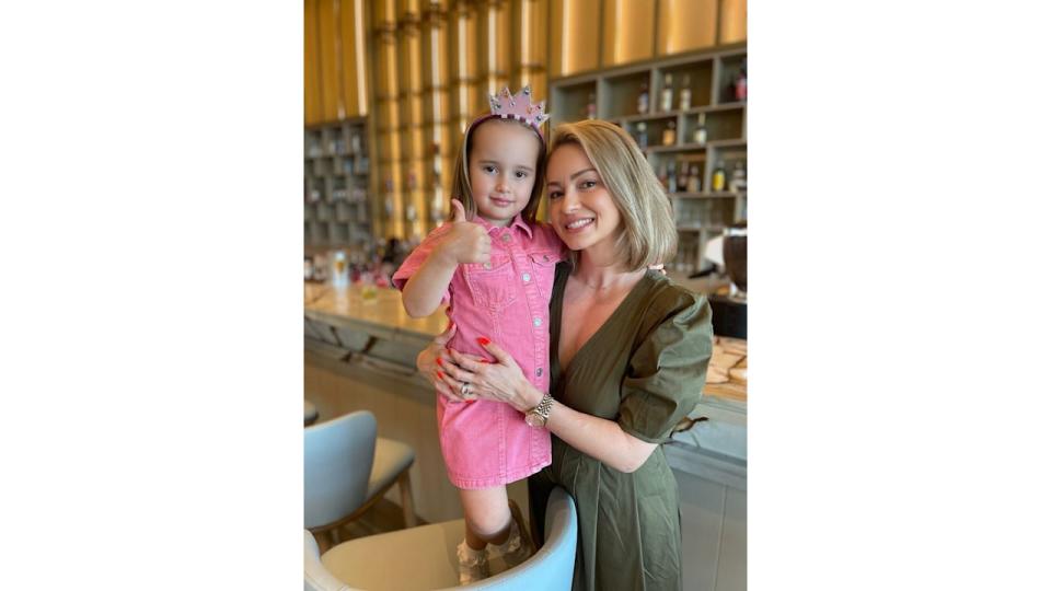 Ella Jordan in pink dress with mum Ola Jordan in khaki dress