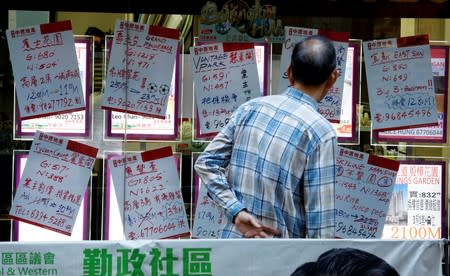 Discounted sale prices for residential flats are displayed at a property agency in Hong Kong