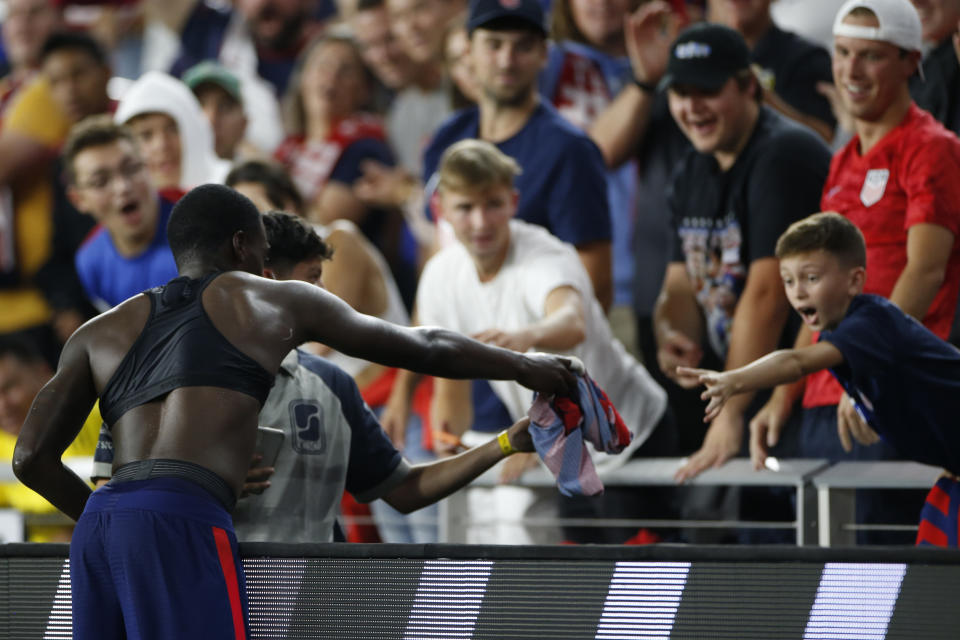 United States' Tim Weah, left, gives his jersey to a fan as he leaves the World Cup qualifying soccer match against Costa Rica during the second half Wednesday, Oct. 13, 2021, in Columbus, Ohio. The United States won 2-1. (AP Photo/Jay LaPrete)