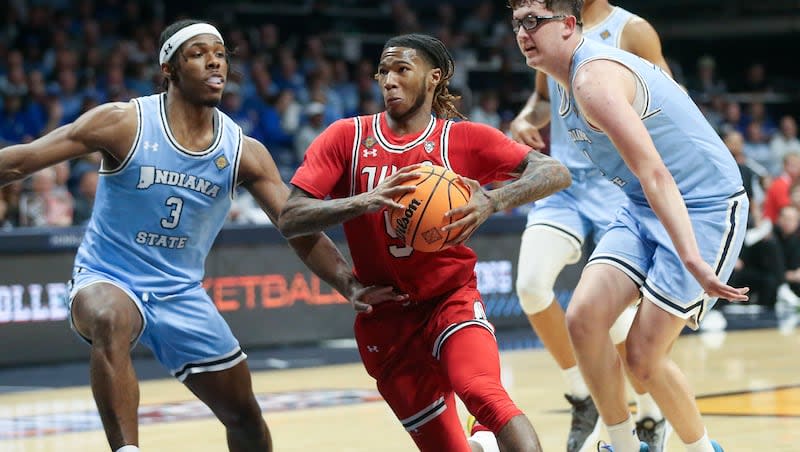 Utah Utes guard Deivon Smith (5) moves between Indiana State Sycamores guard Ryan Conwell (3) and center Robbie Avila (21) during an NIT semifinal basketball game at the Hinkle Fieldhouse in Indianapolis on Tuesday, April 2, 2024. Utah lost 100-90.