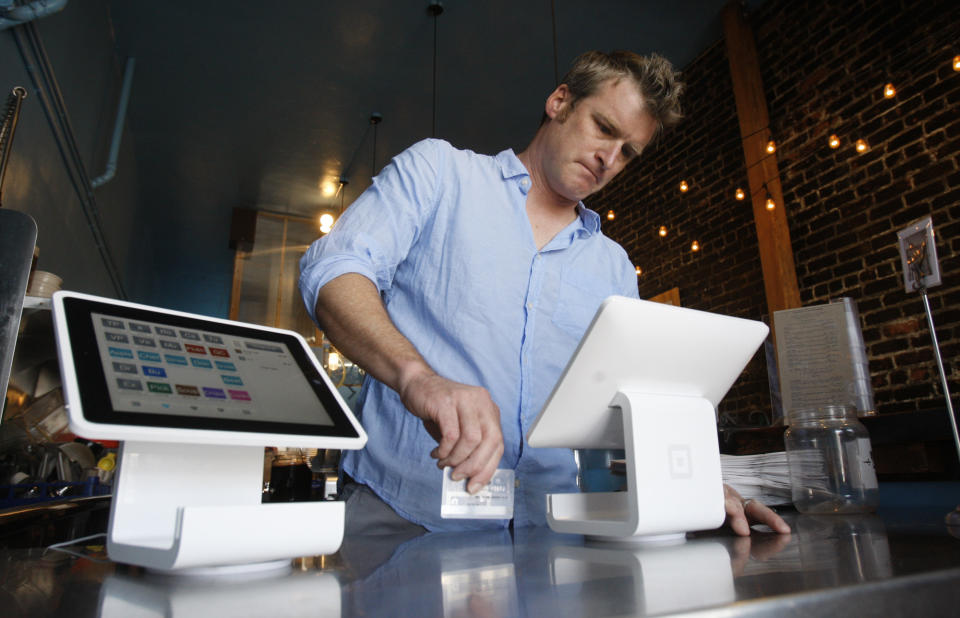 Matt Schodorf, owner of Schodorf's Luncheonette, swipes a credit card on the Square Stand at his restaurant, of which he owns in the Highland Park area of Los Angeles on June 5, 2013. The Square Stand rings customers up on Squares applications. Merchants fed up with the clunky system they have for processing credit and debit card payments are moving increasingly to credit card swiping machines that plug into mobile pads. And Square and PayPal are launching initiatives in the hopes of getting their slice of the action. This is one of 13 establishments nationwide who have this technology, two in California.  (Photo by Gary Friedman/Los Angeles Times via Getty Images)