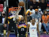 Phoenix Suns forward Mikal Bridges (25) goes in for a dunk as Los Angeles Clippers guard Rajon Rondo (4) looks on during the first half of Game 1 of the NBA basketball Western Conference finals Sunday, June 20, 2021, in Phoenix. (AP Photo/Ross D. Franklin)