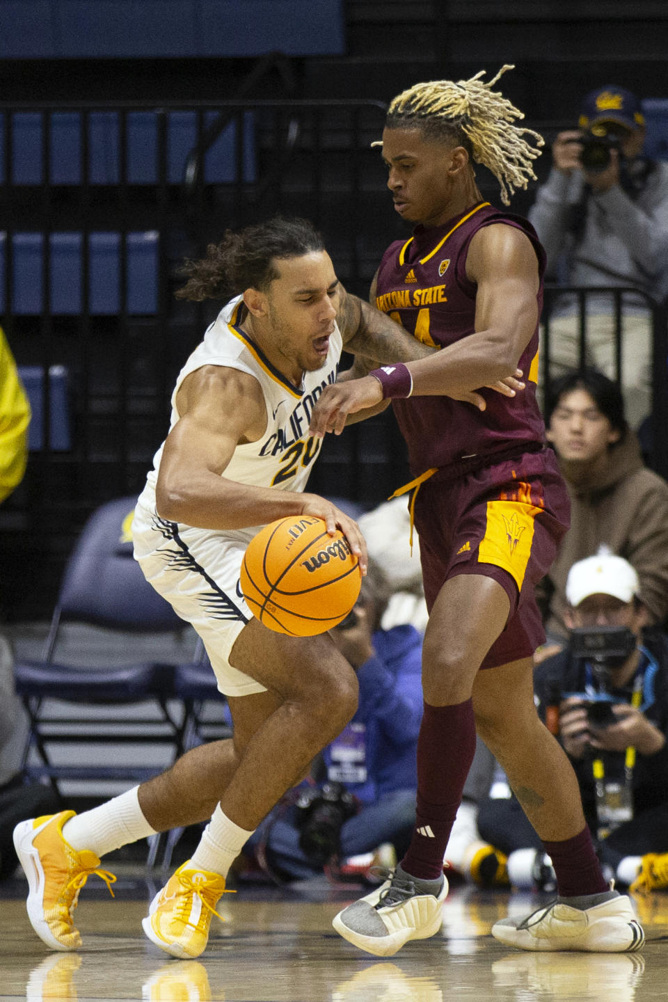 California guard Jaylon Tyson (20) attempts to drive around Arizona State guard Adam Miller, right, during the first half of an NCAA college basketball game, Sunday, Dec. 31, 2023, in Berkeley, Calif. (AP Photo/D. Ross Cameron)
