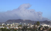 <p>Smoke from the Creek wildfire in the San Gabriel Mountains, the second range behind the Hollywood Hills, home of the Hollywood sign, looms up over Los Angeles Tuesday morning, Dec. 5, 2017. (Photo: Reed Saxon/AP) </p>