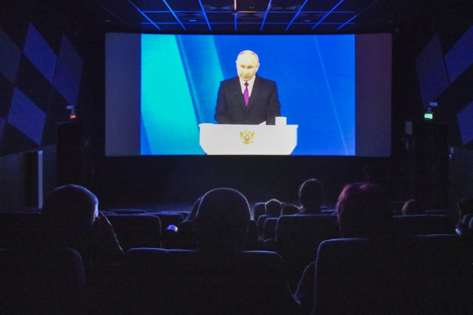 FILE - People watch a broadcast of Russian President Vladimir Putin's state-of-the-nation address in a cinema in St. Petersburg, Russia, Thursday, Feb. 29, 2024. (AP Photo, File)