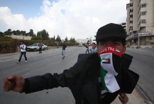 A Palestinian youth gestures during clashes with Israeli forces in the Halhul village near the West Bank city of Hebron. Israeli strikes killed 32 Palestinians on Monday, taking the Gaza death toll to 109 as UN chief Ban Ki-moon joined efforts to end the worst violence in four years and Israel's inner circle of ministers mulled their next move