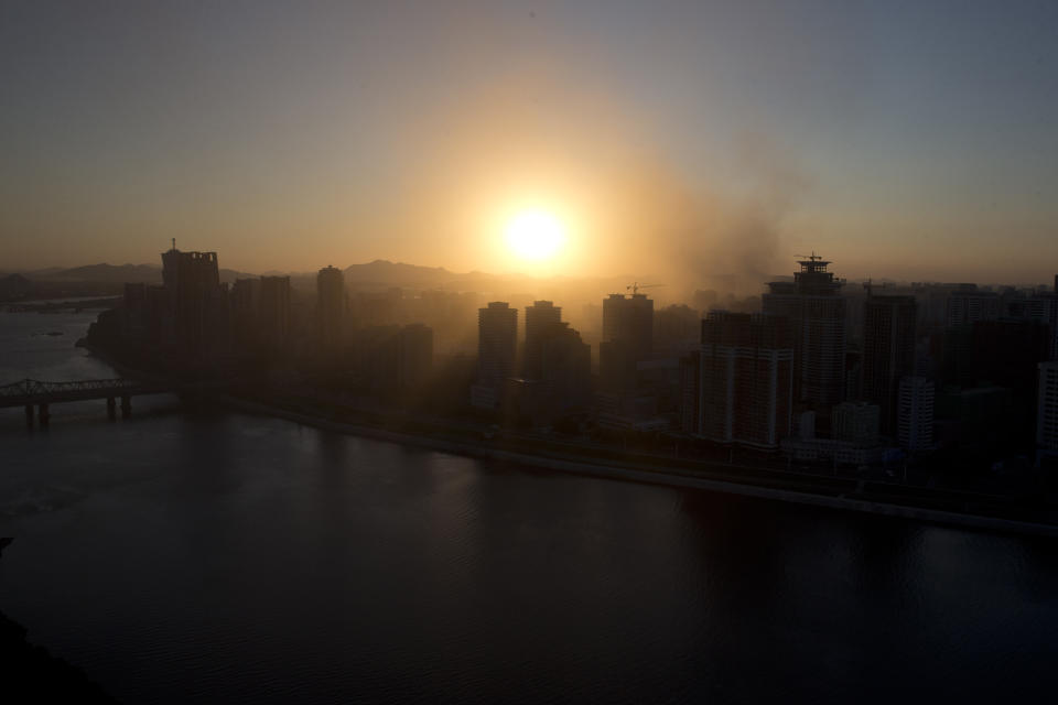 The sun sets over the capital as it prepares for the 70th anniversary of North Korea's founding day in Pyongyang, North Korea, Friday, Sept. 7, 2018. North Korea will be staging a major military parade, huge rallies and reviving its iconic mass games on Sunday to mark its 70th anniversary as a nation. (AP Photo/Ng Han Guan)