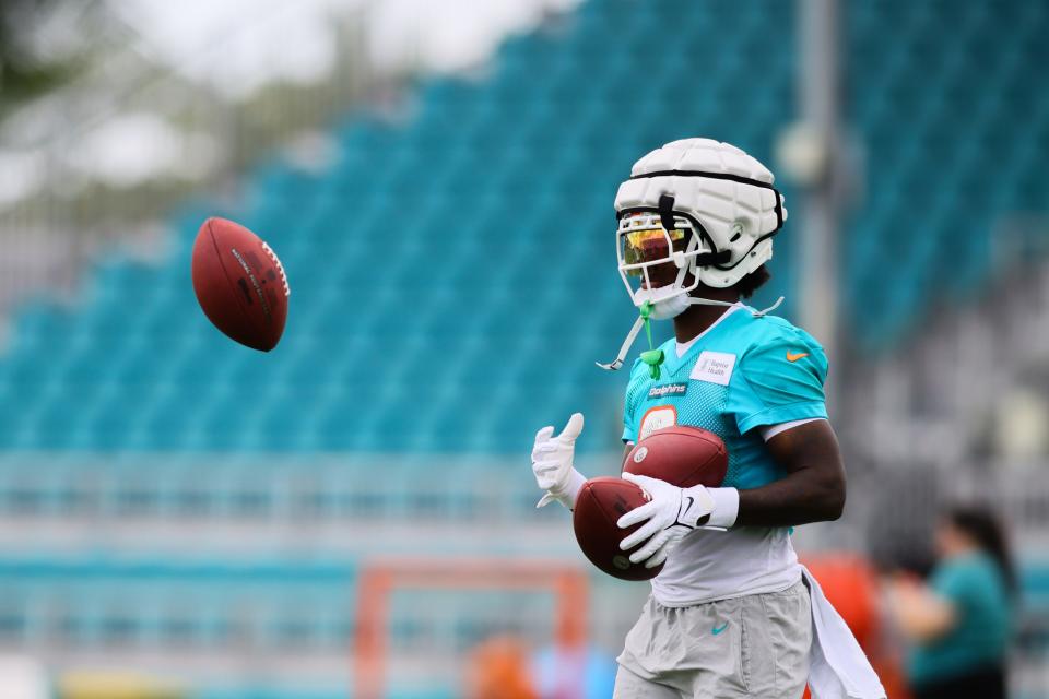 Jul 24, 2024; Miami Gardens, FL, USA; Miami Dolphins safety Jevon Holland (8) juggles with footballs during training camp at Baptist Health Training Complex. Mandatory Credit: Sam Navarro-USA TODAY Sports