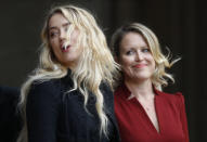 American actress Amber Heard, former wife of actor Johnny Depp, left, and lawyer Jennifer Robinson arrive to give a statement outside the High Court in London, Tuesday, July 28, 2020. Hollywood actor Johnny Depp is suing News Group Newspapers over a story about his former wife Amber Heard, published in The Sun in 2018 which branded him a 'wife beater', a claim he denies. (AP Photo/Alastair Grant)