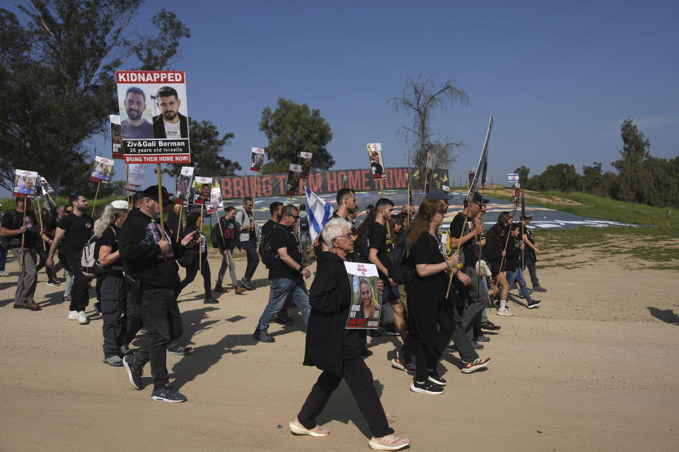 Families of hostages held by Hamas in the Gaza Strip march in Re'im, southern Israel, as they head to Jerusalem calling for the release of hostages, Wednesday, Feb. 28, 2024. They began the four-day march at the site where hundreds of revelers at the Nova music festival were killed or captured by Hamas on Oct. 7, 2023. (AP Photo/Tsafrir Abayov)