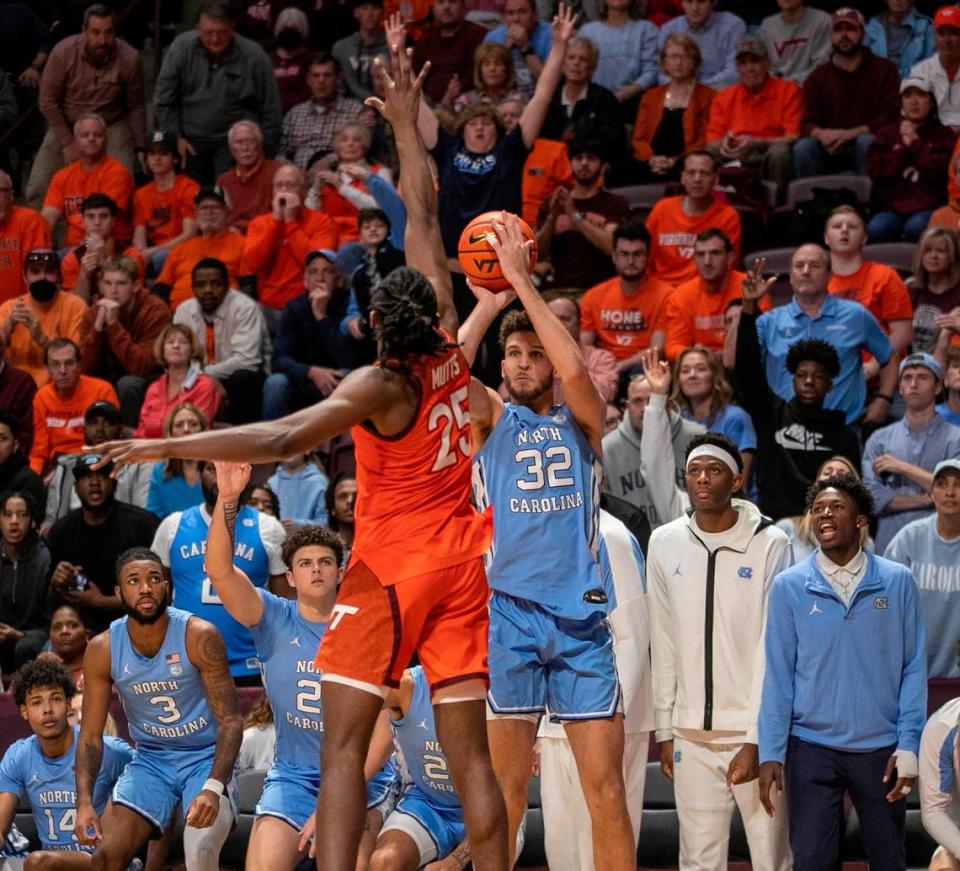 North Carolina’s Pete Nance (32) launches a three point shot against Virginia Tech’s Justyn Mutts (25) during the second half half on Sunday, December 4, 2022 at Cassell Coliseum in Blacksburg, Va. Nance scored 18 points in the Tar Heels’ 80-72 loss.