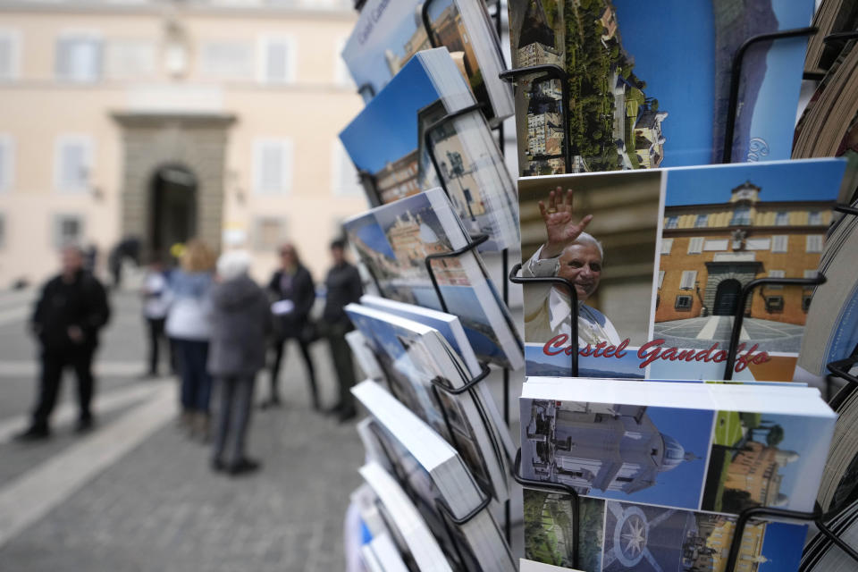 Postcards of the late Pope Emeritus Benedict XVI are displayed in a shop in Castel Gandolfo, in the hills south of Rome, Tuesday Jan. 3, 2023. Benedict's death has hit Castel Gandolfo's "castellani" particularly hard, since many knew him personally, and in some ways had already bid him an emotional farewell on Feb. 28, 2013, when he uttered his final words as pope from the palace balcony overlooking the town square. (AP Photo/Alessandra Tarantino)