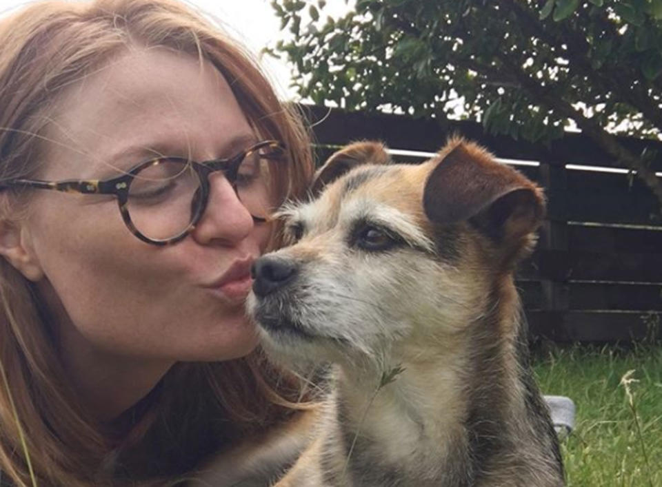 Emma Berquist kisses her dog.