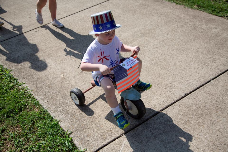 Payton Parrish, 4, rides in an Independence Day parade at Riverwalk Park in Columbia on Thursday, July 4, 2019. 