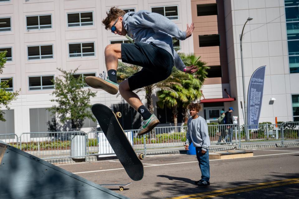 Local skateboarders practice their moves in the Vystar Family Skate Park outside the main SLS competition on Sunday.