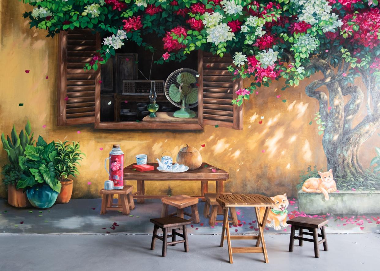 A traditional tea table sits in front of a large mural inside TeaVa Rolls, a new casual Vietnamese restaurant that opened in Doylestown, on Tuesday, March 19, 2024.