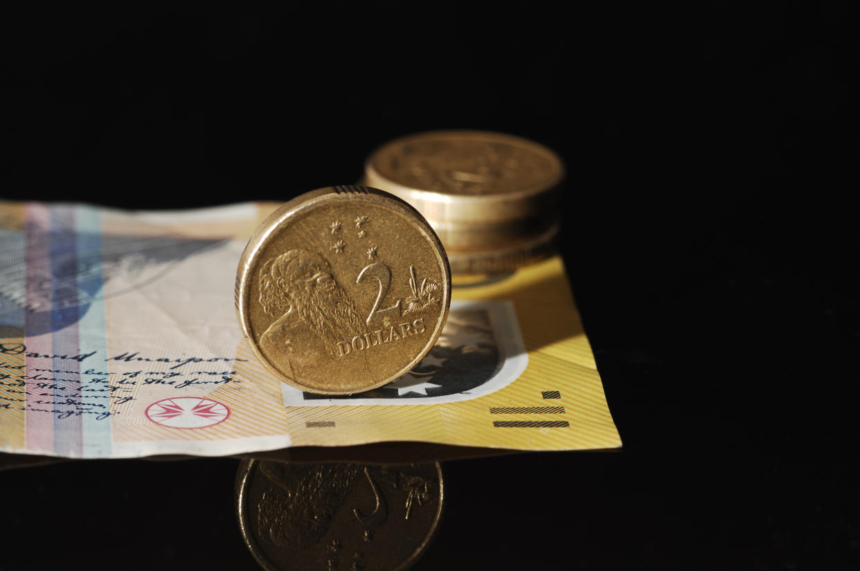 Close up of an Australian $2 coin on a $50 note