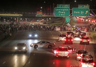 <p>Demonstrators hold signs as they as they block traffic on Interstate 94 in St. Paul, Minn., after leaving a vigil at the state Capitol on Friday, June 16, 2017. A Minnesota police officer was cleared Friday in the fatal shooting of Philando Castile, a black motorist whose death captured national attention when his girlfriend streamed the grim aftermath on Facebook. (Anthony Souffle/Star Tribune via AP) </p>