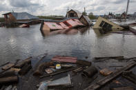 <p>Destroyed houses in the town of Ishim, Tyumen Region. According to the Tyumen Region Branch of the Russian Emergency Situations Ministry 5934 summer houses and 53 residential houses are flooded in the town of Ishim, 674 summer houses and 77 residential houses are flooded in the Ishim District. (Photo: Dmitry FeoktistovTASS via Getty Images) </p>