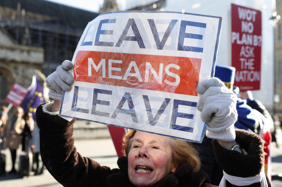 Pro and Anti Brexit protesters demonstrate outside the Houses of Parliament in London, Monday, Jan. 28, 2019. British Prime Minister Theresa May faces another bruising week in Parliament as lawmakers plan to challenge her minority Conservative government for control of Brexit policy. (AP Photo/Alastair Grant)