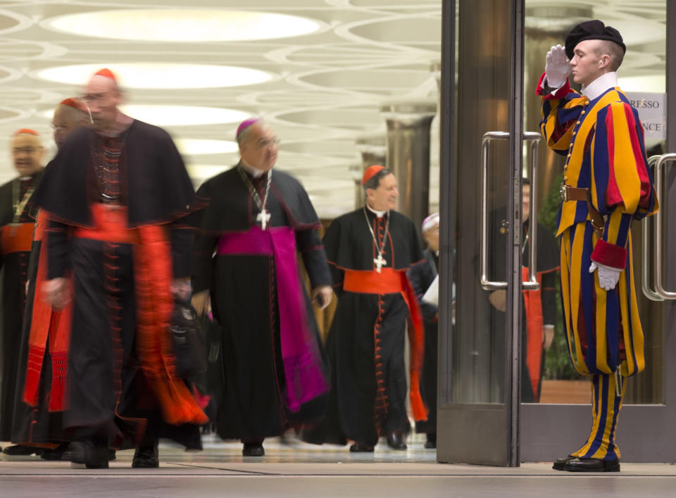 Cardinals and bishops leave at the end of the afternoon session of an extraordinary consistory in the Synod hall at the Vatican City, Thursday, Feb. 20, 2014. Cardinals from around the globe have begun discussing some of the most contentious issues in the church amid findings from Vatican-mandated surveys that most Catholics reject church teaching on contraception, divorce and homosexuality. Pope Francis opened the two-day meeting Thursday by urging his cardinals to find "intelligent, courageous" ways to help families under threat today without delving into case-by-case options to get around Catholic doctrine. (AP Photo/Alessandra Tarantino)