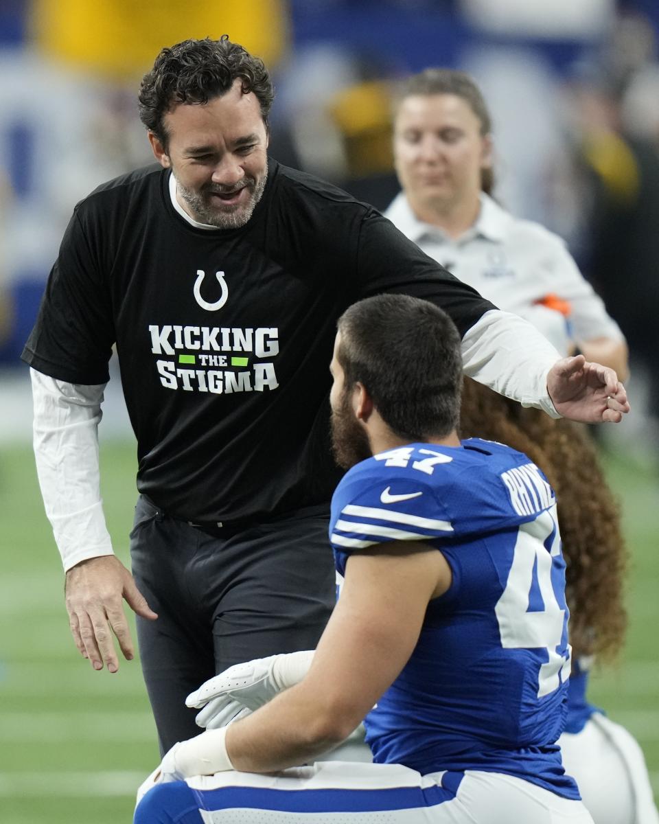 Indianapolis Colts interim head coach Jeff Saturday, left, talks with Forrest Rhyne before an NFL football game against the Pittsburgh Steelers, Monday, Nov. 28, 2022, in Indianapolis. (AP Photo/AJ Mast)