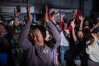 <p>Onlookers at Chiangrai Prachanukroh Hospital cheer as ambulances transport the last rescued schoolboys and their coach from a helipad to the hospital on July 10, 2018, in Chiang Rai, Thailand. Videos released by the Thai navy SEALs showed the boys, ages 11 to 16, and their 25-year-old coach are in good health. (Photo: Linh Pham/Getty Images) </p>