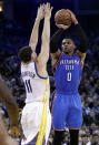 Oklahoma City Thunder's Russell Westbrook (0) shoots over Golden State Warriors' Klay Thompson (11) during the first half of an NBA basketball game Wednesday, Jan. 18, 2017, in Oakland, Calif. (AP Photo/Marcio Jose Sanchez)