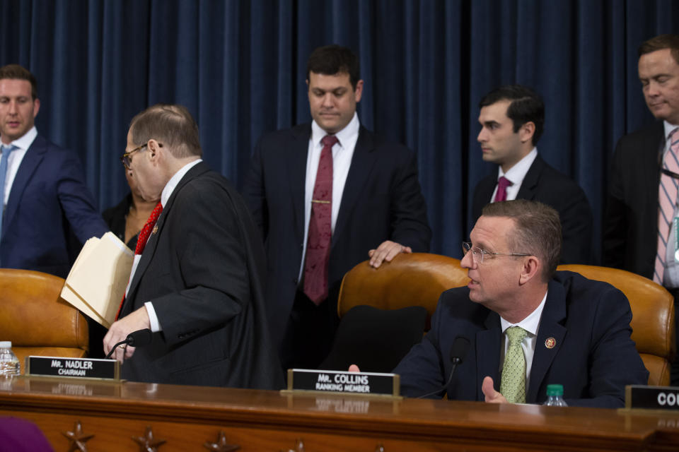House Judiciary Committee Chairman Rep. Jerrold Nadler, D-N.Y., left, leaves as ranking member Rep. Doug Collins, R-Ga., seated right, speaks after adjournment following a marathon debate during a markup of the articles of impeachment against President Donald Trump, on Capitol Hill, Thursday, Dec. 12, 2019, in Washington. The House Judiciary Committee abruptly postponed a historic vote, shutting down a divisive 14-hour session that dragged with sharp partisan divisions but has been expected to end with the charges being sent to the full House for a vote next week. (AP Photo/Alex Brandon)