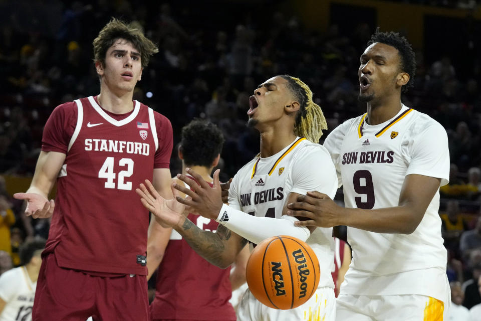 Arizona State guard Adam Miller, center, shouts after being fouled by Stanford Cardinal forward Maxime Raynaud (42) as Arizona State center Shawn Phillips Jr. (9) reacts to the missed shot during the second half of an NCAA college basketball game Thursday, Feb. 1, 2024, in Tempe, Ariz. Stanford won 71-62. (AP Photo/Ross D. Franklin)