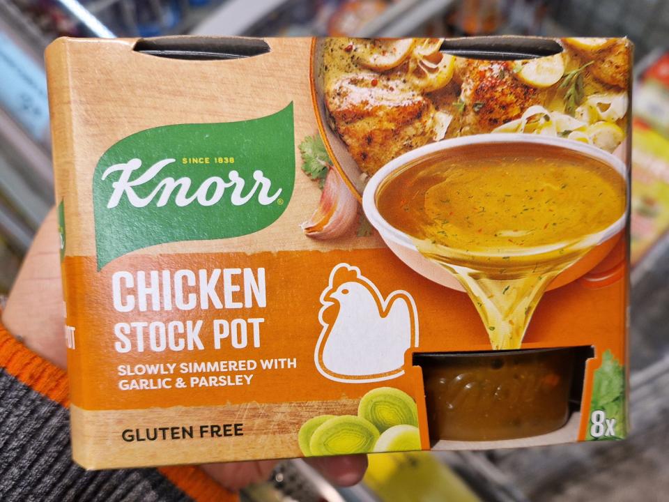 The writer holds a box of Knorr chicken stock
