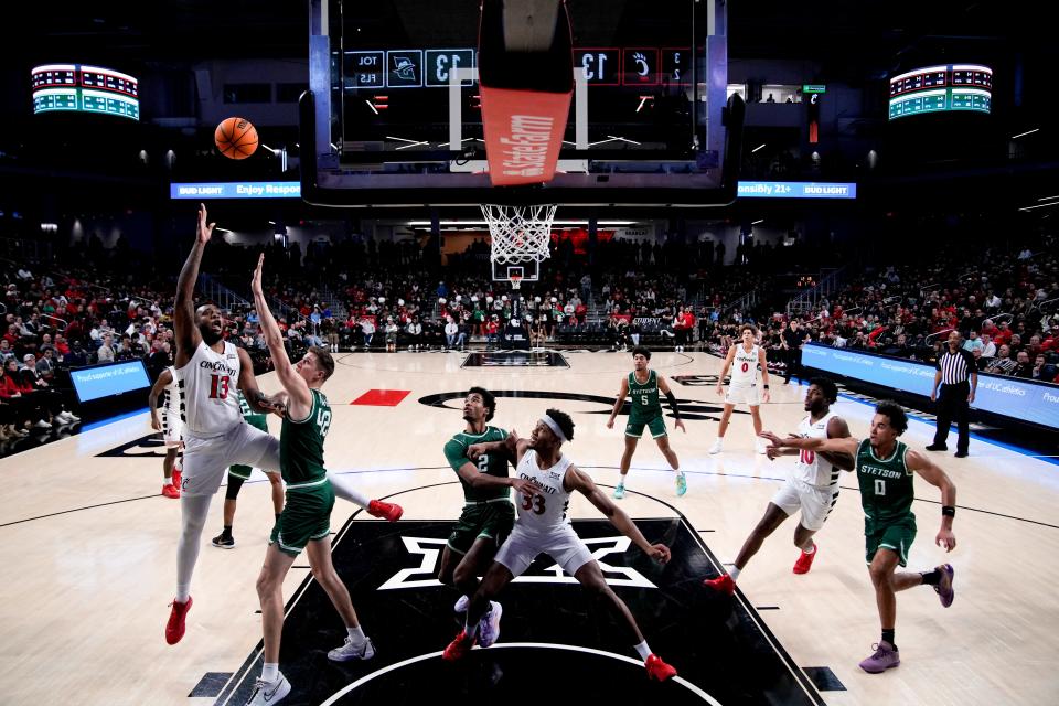 Cincinnati Bearcats forward Jamille Reynolds (13) hits a basket over Stetson Hatters forward Treyton Thompson (42). Reynolds finished with 14 points on the night, his best outing in his short time as a Bearcat.