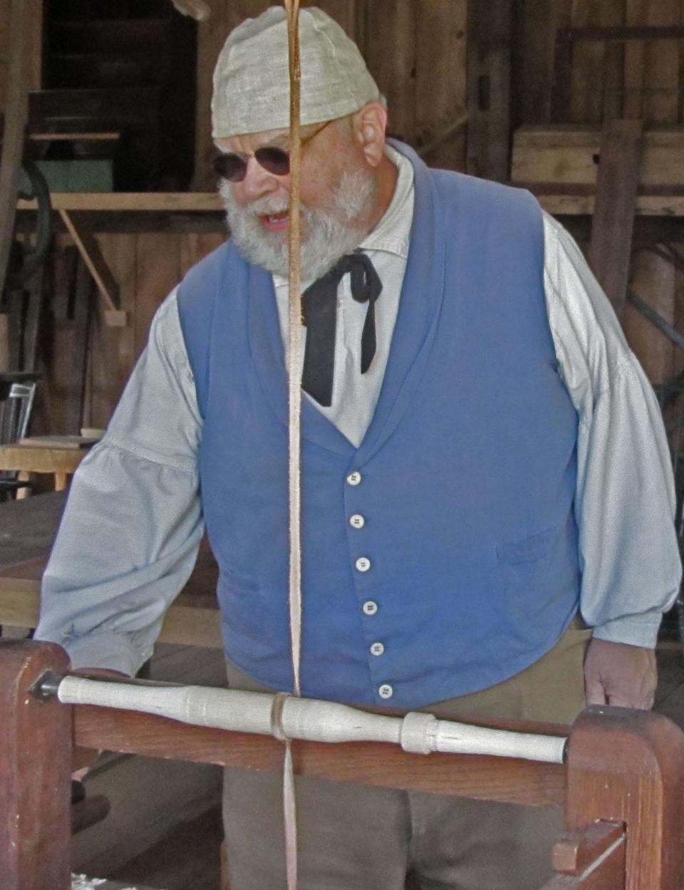 Mike Borgeest demonstrates a spring pole lathe when making a Windsor chair in the woodshop at Genesee Country Village & Museum.