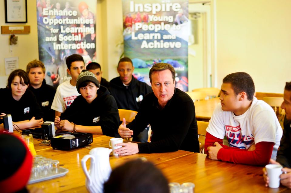 Cameron speaks to teenagers at a scheme in Wales in 2012PA