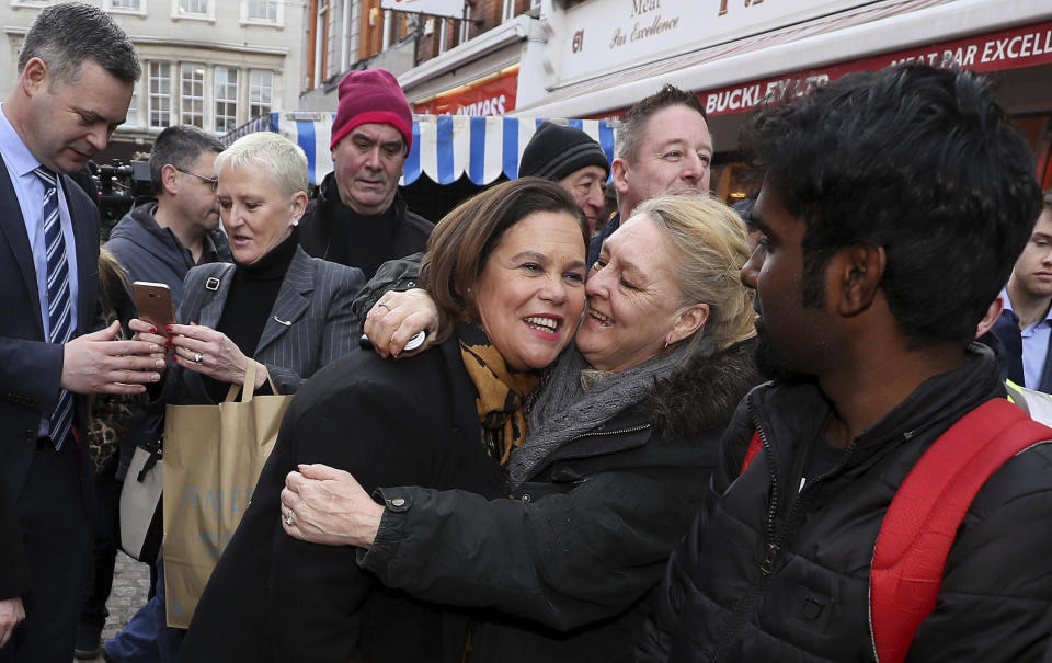 Sinn Fein leader Mary Lou McDonald, center, is greeted by well wishers during a walkabout in central Dublin during a walkabout in central Dublin, whilst on the General Election campaign trail on Thursday, Feb. 6, 2020. Ireland goes to the polls for a general election on Feb. 8. (Brian Lawless/PA via AP)