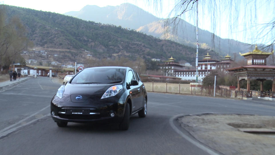 In this undated photo released Friday, Feb. 21, 2014 by Nissan Motor Co., the Japanese automaker's electric car Leaf runs in Thimphu in Bhutan. The Himalayan kingdom of Bhutan and Nissan are partnering on electric cars, with the Japanese automaker's Leaf being chosen for the government fleet and taxis. Under a deal announced Friday, Feb. 21, 2014, Nissan will help Bhutan achieve its goal of becoming a zero-emissions nation. (AP Photo/Nissan Motor Co.)