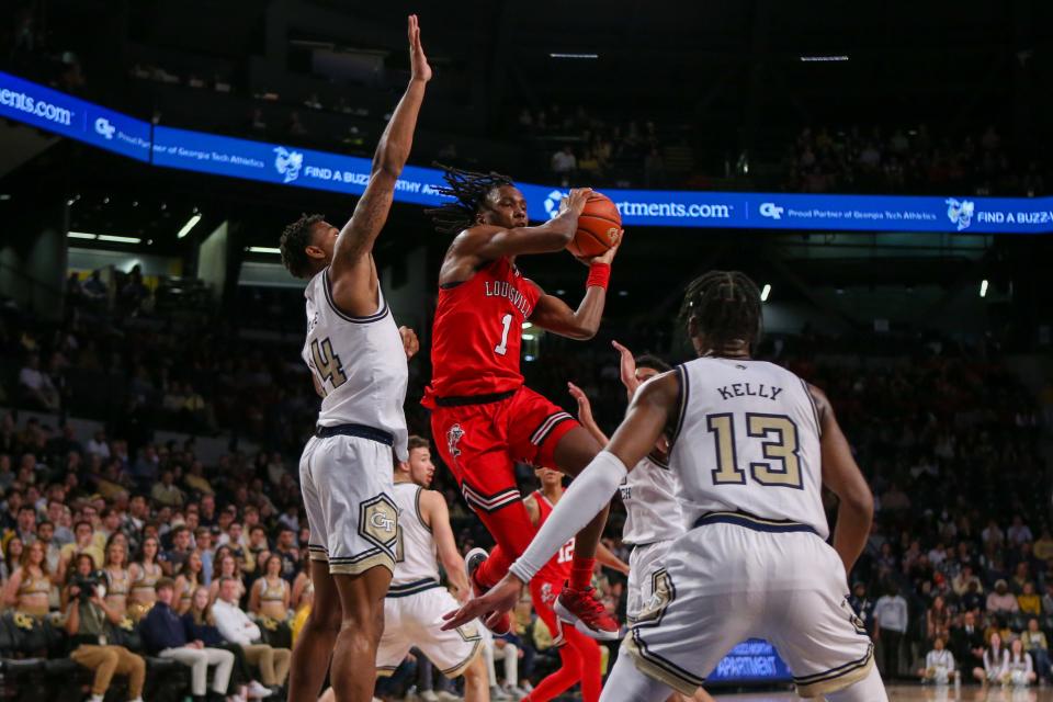 Feb 25, 2023; Atlanta, Georgia, USA; Louisville Cardinals guard Mike James (1) drives on Georgia Tech Yellow Jackets forward Jalon Moore (14) and guard Miles Kelly (13) in the first half at McCamish Pavilion. Mandatory Credit: Brett Davis-USA TODAY Sports