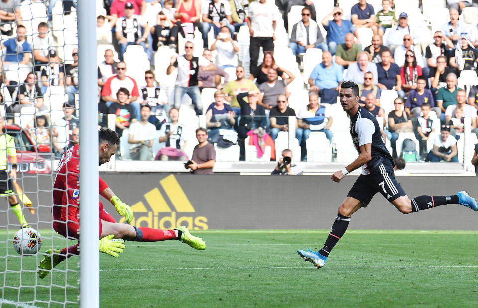 Juventus' Cristiano Ronaldo, right, scores during the Serie A soccer match between Juventus and Spal, at the Allianz Stadium in Turin, Italy, Saturday, Sept. 28, 2019. (Alessandro Di Marco/ANSA via AP)