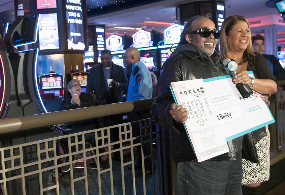 Robert Bailey, left, is joined by New York Lottery's Yolanda Vega as he speaks to reporters during a news conference at the Resorts World Casino New York City, Wednesday, Nov. 14, 2018, in New York. The retired government worker won over $343 million in Powerball, the biggest jackpot in New York state lottery history. (AP Photo/Mary Altaffer)