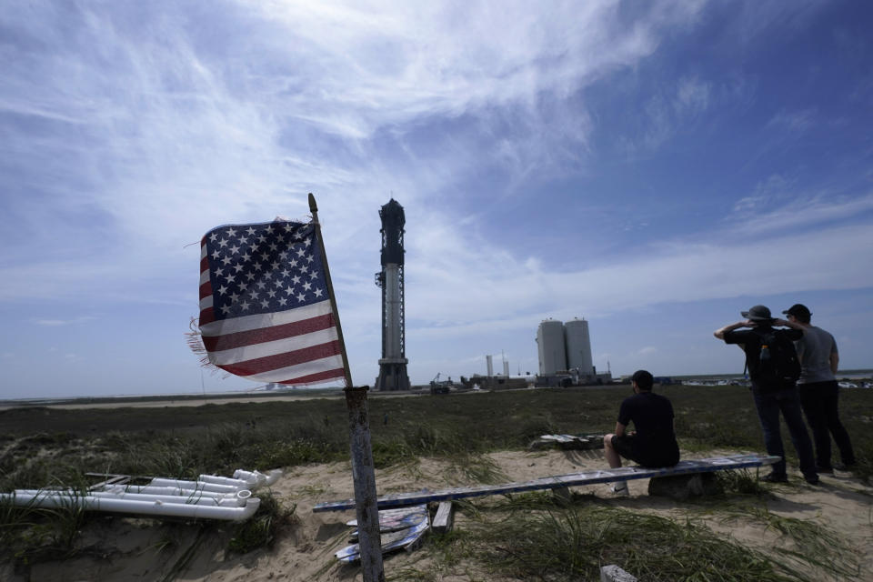 FILE - Onlookers watch as SpaceX's Starship, the world's biggest and most powerful rocket, stands ready for launch in Boca Chica, Texas, Sunday, April 16, 2023. SpaceX would acquire public land in Texas to expand its rocket launch facilities under a tentative deal that is moving forward after months of opposition from nearby residents and some local officials near the U.S.-Mexico border. (AP Photo/Eric Gay, File)