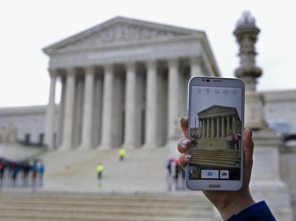 A person outside of the Supreme Court in 2014, when it heard arguments in the cellphone privacy case Riley v. California. Jose Luis Magana/AP