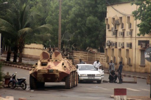 Soldiers loyal to Captain Amadou Haya Sanogo sit on an armoured vehicle at the Patrice Lumouda roundabout in Bamako last week. A month after handing power to civilians, Mali's ex-junta is resisting a return to barracks, threatening to disrupt a transition to democratic rule in Bamako while Islamists retain a firm hold on the north