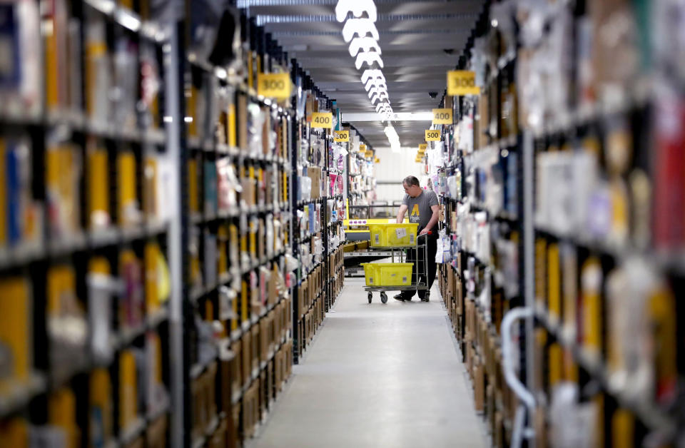 Staff make their way around the aisles collecting items before sending them to the on-site dispatch hall to be packaged inside one of Britain's largest Amazon warehouses in Dunfermline, Fife, as the online shopping giant gears up for the Christmas rush and the forthcoming Black Friday sales.