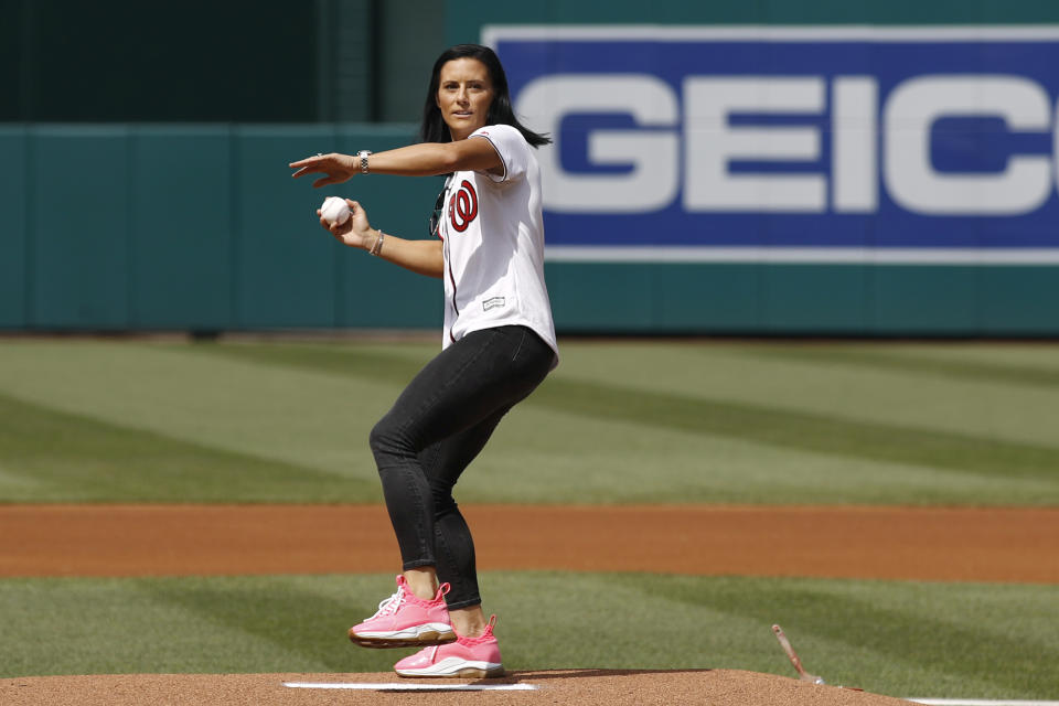 Ali Krieger, a member of the United States women's national soccer team, throws out a ceremonial first pitch before a baseball game between the Colorado Rockies and the Washington Nationals, Thursday, July 25, 2019, in Washington. (AP Photo/Patrick Semansky)