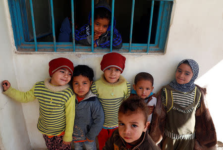 Egyptian children wait outside a new clinic in the province of Fayoum, southwest of Cairo, Egypt February 19, 2019. Picture taken February 19, 2019. REUTERS/Hayam Adel