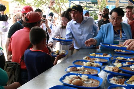 U.S. Secretary of Health and Human Services Secretary Alex Azar distributes lunches, during a visit at the "Divina Providencia"migrant shelter in Cucuta