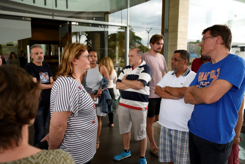 FILE PHOTO: European tourists await for news near the airport as the spread of coronavirus disease (COVID-19) continues in Guayaquil