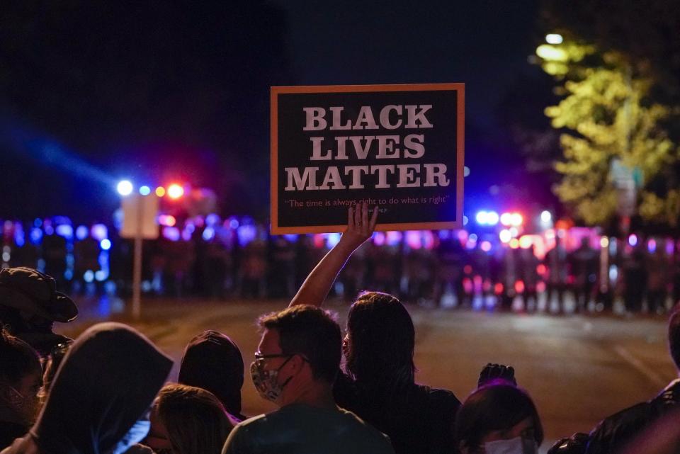 FILE - In this Oct. 2020, file photo, protesters and police line up in Wauwatosa, Wis., in the case against Wauwatosa Police Officer Joseph Mensah for the Feb. 2 fatal shooting of 17-year-old Alvin Cole at Mayfair Mall. A Wisconsin judge was set to announce Wednesday, July 28, 2021, whether he will invoke a rarely used process to charge Mensah in the 2016 slaying of a Black man who was sitting in a parked car. (AP Photo/Morry Gash, File)