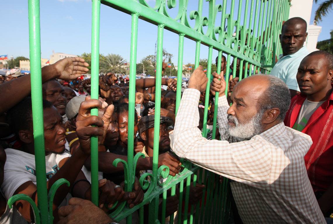 President René Préval meets the people at the gates of the palace on Friday, Jan. 30, 2010, in the aftermath of that year’s deadly Jan. 10 earthquake.  